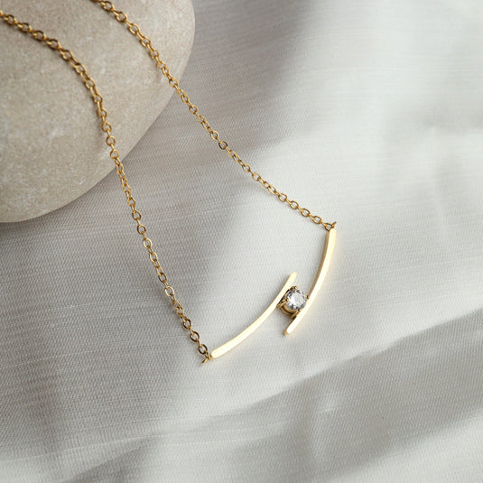 QuinShine elegant diamond bar necklace with gold chain and minimalist design on neutral fabric