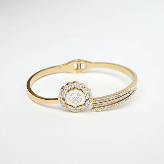 QuinShine gold shell bracelet featuring a shell charm and crystal accents on a gold band