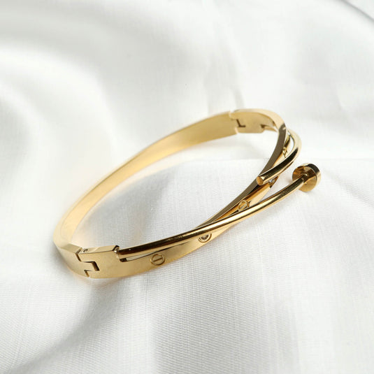 QuinShine gold sleek sculptural bracelet with elegant minimalist design on white fabric