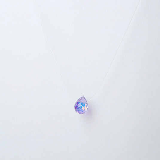QuinShine Lumin teardrop necklace with a purple faceted crystal pendant on a clear cord
