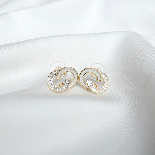 QuinShine Lunar Link gold earrings with elegant interlocking design on white fabric