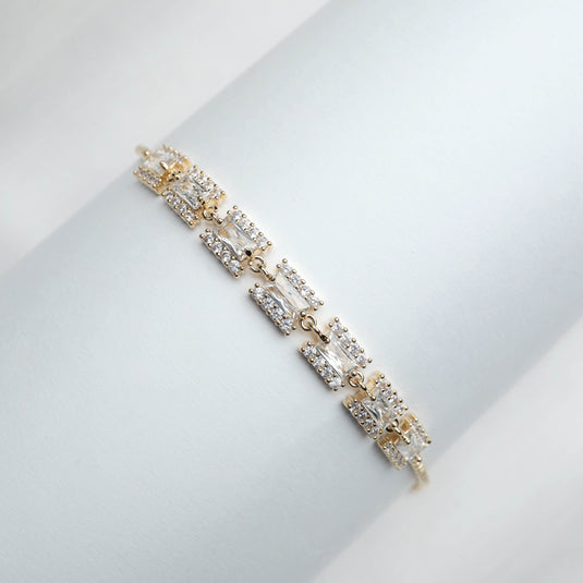 Luxury Gold Radiant Rhythm Bracelet with rectangular clear stones and gold links on white background