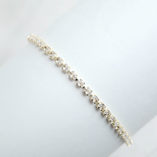 Luxury gold tennis bracelet by QuinShine with sparkling round crystals in a classic design
