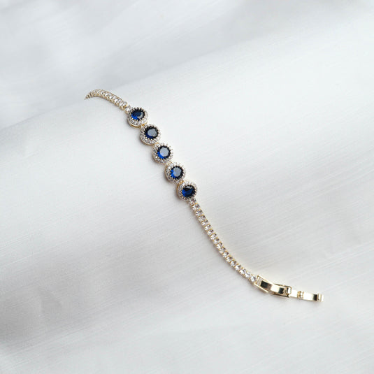 QuinShine Ocean Gaze tennis bracelet featuring blue gemstones and sparkling accents on a silver chain
