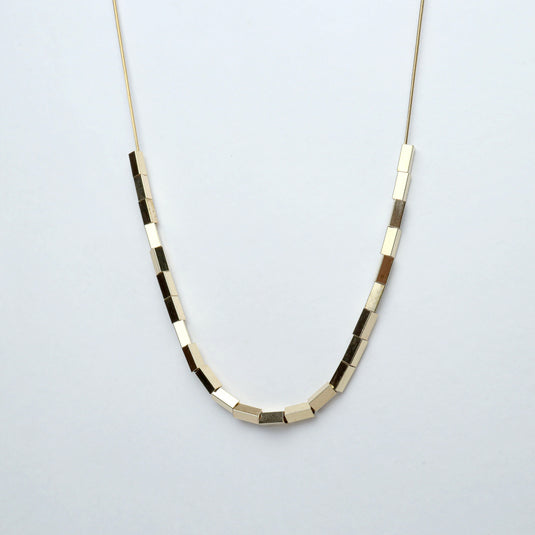 Minimalist necklace featuring unique square bead jewelry in metallic tones from QuinShine online store