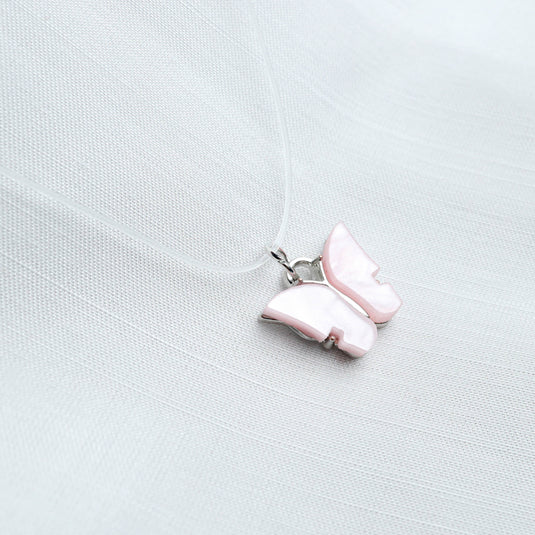 QuinShine pastel butterfly necklace with pink enamel charm on a delicate clear cord