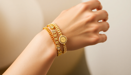 Elegant gold bracelets displayed on a woman’s wrist