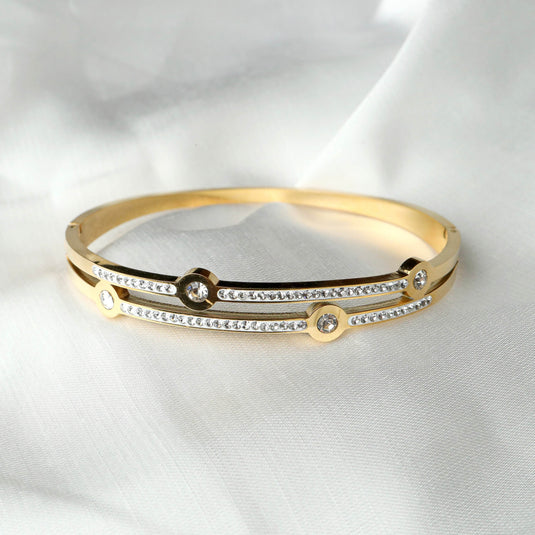 Gold bangle bracelet with sparkling stones featuring a cosmic jewelry design by QuinShine