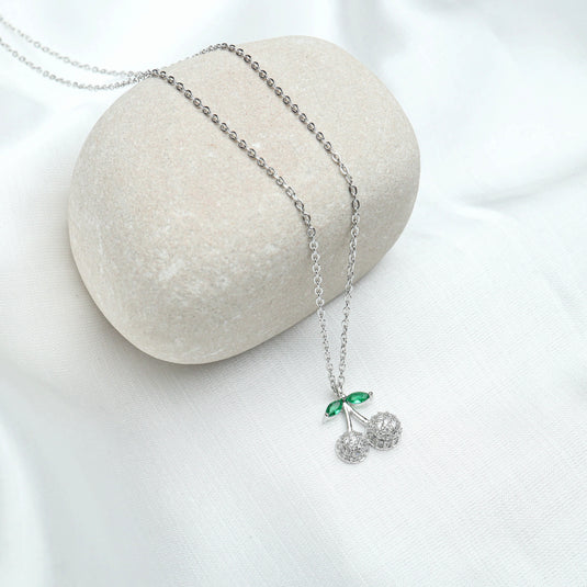 Dainty necklace for women with silver chain and cherry-shaped pendant featuring green leaves and crystal cherries