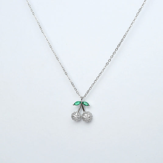 Dainty necklace for women with silver chain and cherry pendant featuring green leaves and crystal cherries