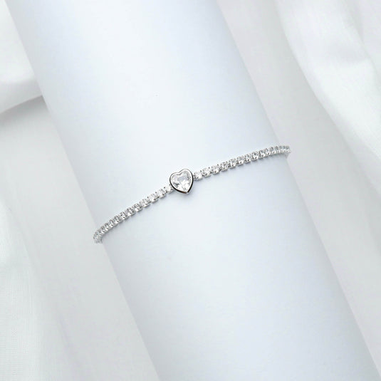 Delicate White heart charm bracelet with sparkling stones on a white display background