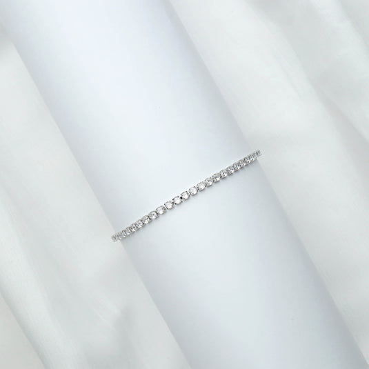 QuinShine elegant diamond tennis bracelet with round cut diamonds on a white display