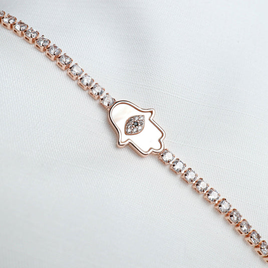 QuinShine Divine Grace Protective Charm bracelet with rose gold and clear stones on white fabric