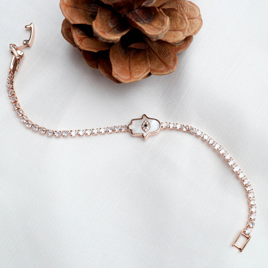 QuinShine Divine Grace Protective Charm bracelet with rose gold and sparkling crystals on white fabric