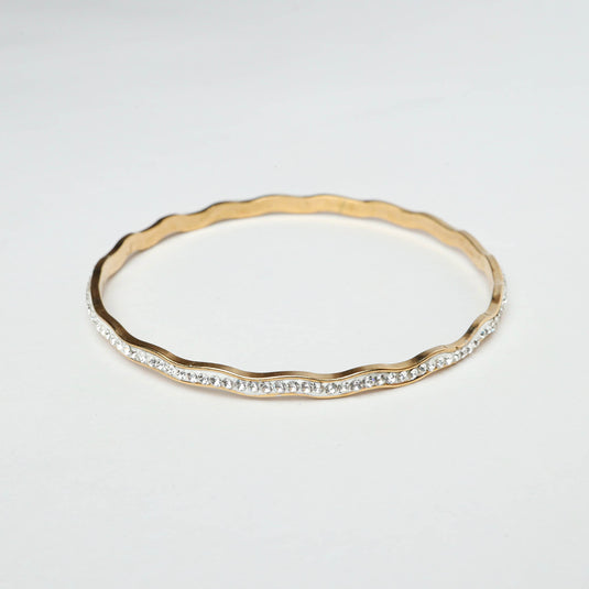 Elegant gold and silver wave bracelet with sparkling stones in a wavy design by QuinShine