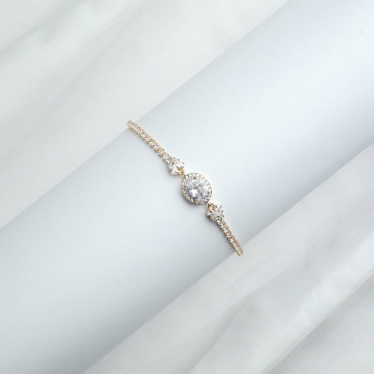 QuinShine elegant gold oval bracelet with sparkling stones on a white background