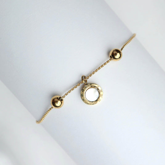 QuinShine elegant gold sphere charm bracelet with two gold spheres and a circular charm on a delicate chain