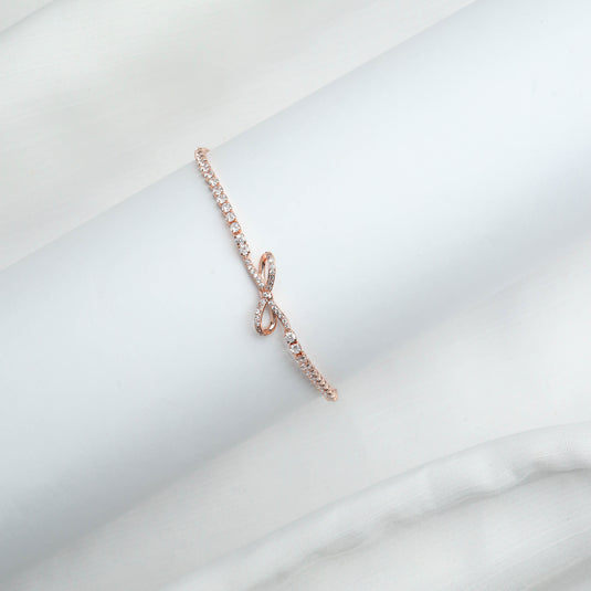 Elegant Rose Gold infinity bracelet with sparkling stones on a white display