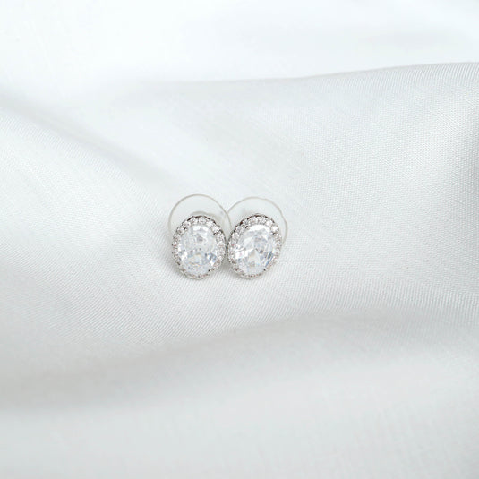 QuinShine round crystal stud earrings showcasing elegant silver jewelry on soft white fabric