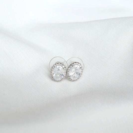 QuinShine elegant silver jewelry oval clear stone stud earrings on white fabric background