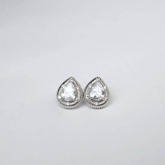 Elegant silver stud earrings with teardrop-shaped clear gemstones and detailed silver edging