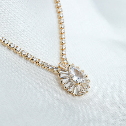 Elysian Sparkle Necklace gold chain with large pear-shaped and baguette crystals on white background