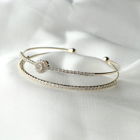 QuinShine Embrace Brilliance Bracelet with delicate gold bands and sparkling crystals on white background