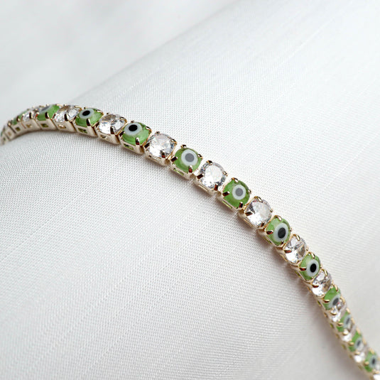 QuinShine Forest Gaze tennis bracelet with alternating green and clear stones on gold setting