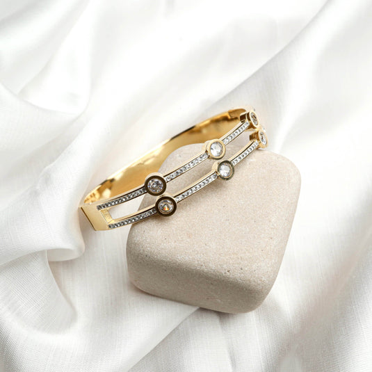 QuinShine Gilded Aura Bracelet with shimmering stones on a gold-tone band