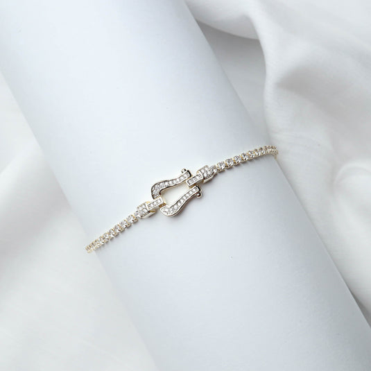 QuinShine gold arc bracelet with diamond accents on a white display wrist
