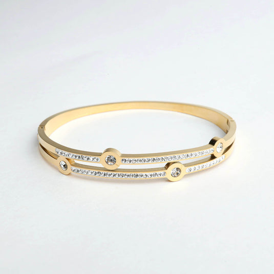 Gold bangle bracelet with clear crystals featuring cosmic jewelry design by QuinShine