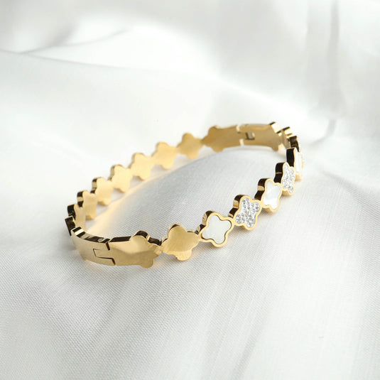 QuinShine elegant gold designer lattice bangle with floral and crystal accents on white fabric