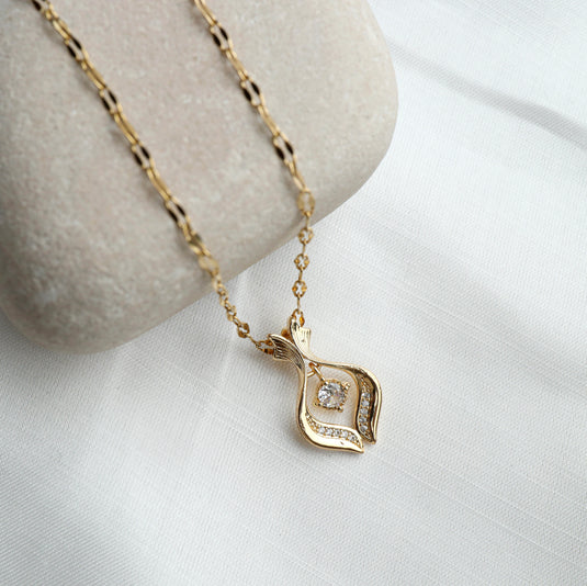 Gold diamond flame pendant necklace with sparkling diamonds on a delicate chain by QuinShine