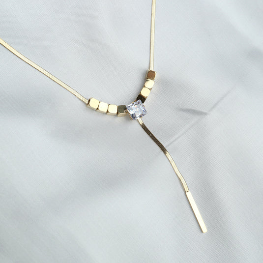 Elegant diamond pendant lariat necklace with gold chain and square crystal centerpiece