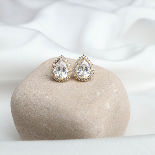 QuinShine gold drop earrings with teardrop shaped clear stones surrounded by small gold beads