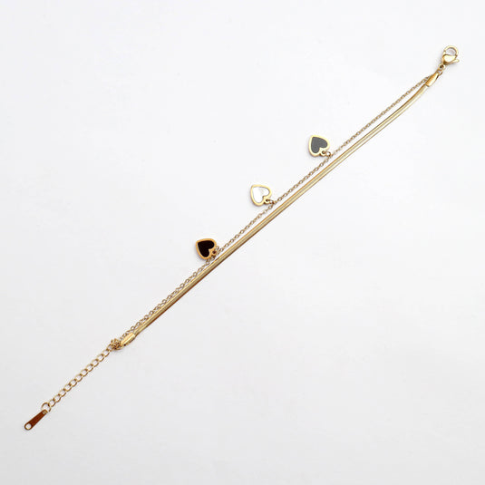 QuinShine delicate gold heart charm bracelet with three black and white heart pendants