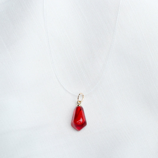 QuinShine elegant sheer necklace with a red pendant on a transparent cord against a white background