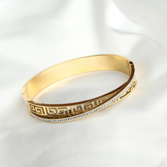 QuinShine Greek Key Bracelet Gold with intricate geometric design and crystal accent on white fabric background