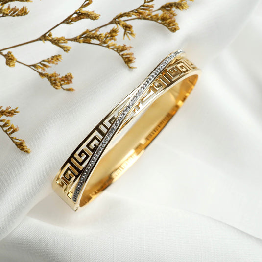 QuinShine Greek Key Bracelet Gold with intricate pattern and silver accents on white fabric