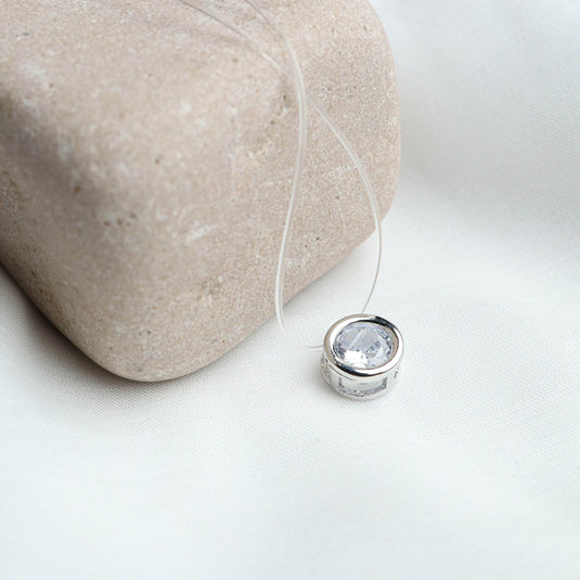 QuinShine halo bezel necklace with round clear gemstone pendant on transparent cord