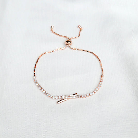Delicate rose gold bracelet with sparkling stones and intersect design jewelry detail