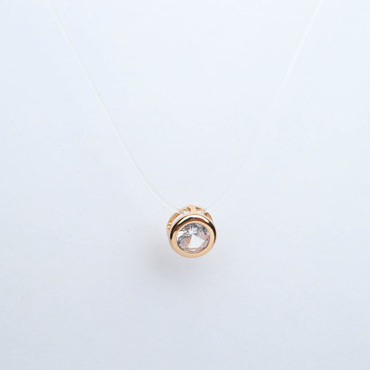 QuinShine gold pendant with clear gemstone on invisible chain fashion jewelry against white background