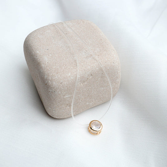QuinShine invisible chain fashion jewelry necklace with clear chain and gold pendant featuring a round crystal stone