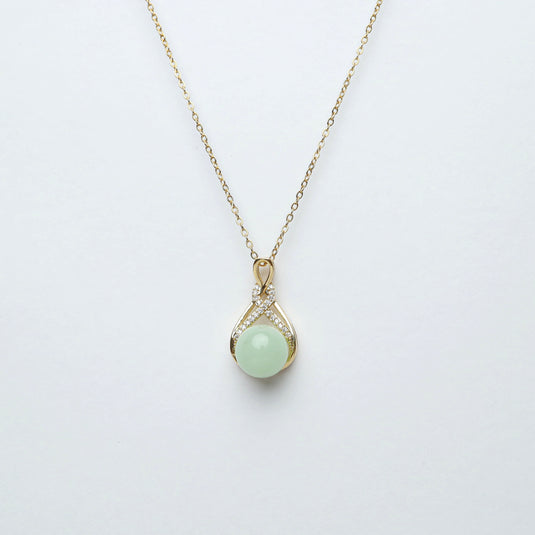 Elegant jade pendant necklace with a round green jade stone and gold chain from QuinShine