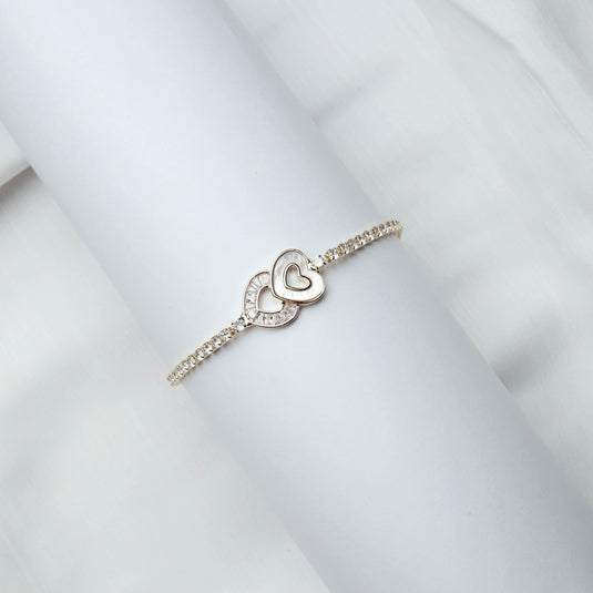 QuinShine love knot tennis bracelet with heart-shaped design and sparkling stones on white background