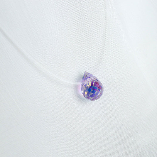 QuinShine Lumin teardrop necklace featuring a faceted iridescent purple pendant on a clear cord