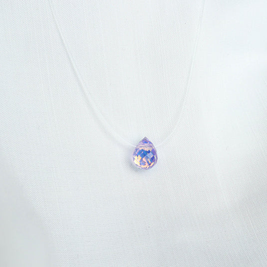 QuinShine Lumin teardrop necklace with a purple faceted pendant on a clear cord