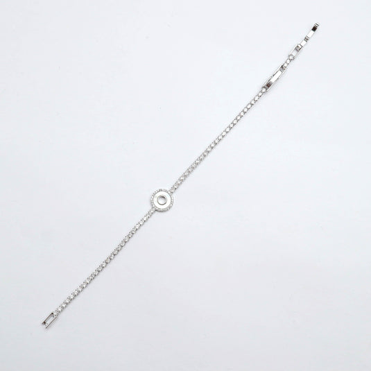 QuinShine Lunar Glow tennis bracelet featuring a delicate silver chain with a circular centerpiece
