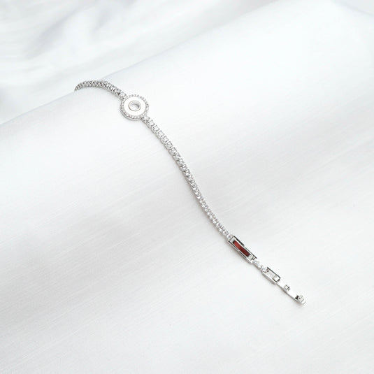 QuinShine Lunar Glow tennis bracelet with delicate silver chain and circular centerpiece on white background