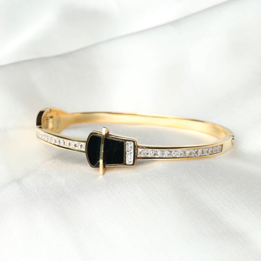 QuinShine luxury black stone bracelet with gold band and clear crystals on a white fabric background